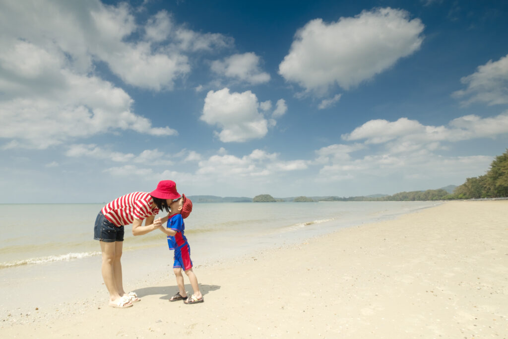 A mother and son on beach outdoors Sea and Blue sky
